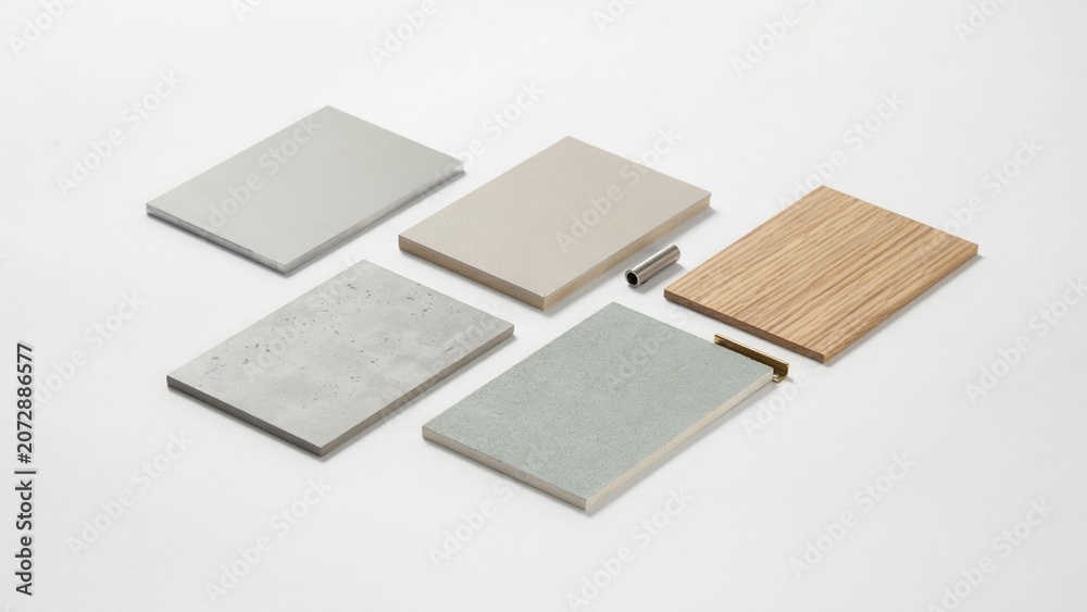 Fototapeta premium Sample boards in various textures and materials are laid out on a clean white surface for interior design projects.