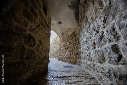 Slika na platnu Narrow vaulted stone alleyway winding through the historic Jewish Quarter in the