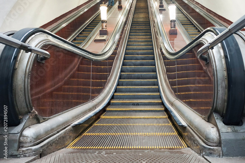 Subway escalator. A moving staircase for ascending or descending with an electric drive.