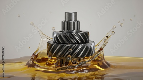 Metal gears splashing into engine oil on neutral background