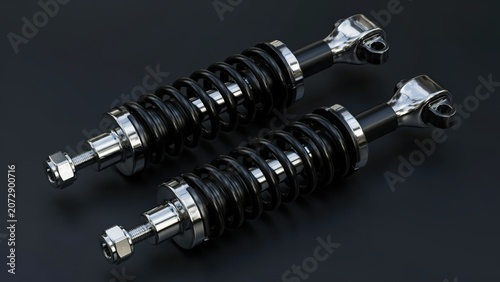 Pair of high performance motorcycle shock absorbers with black springs on dark background