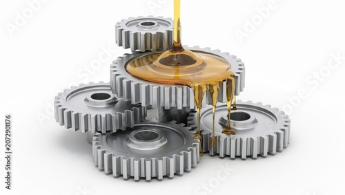 Golden industrial oil pouring over a stack of metal gears isolated on white background