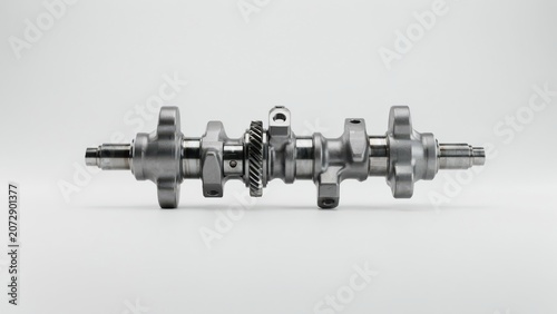 Metal crankshaft with gear isolated on white background