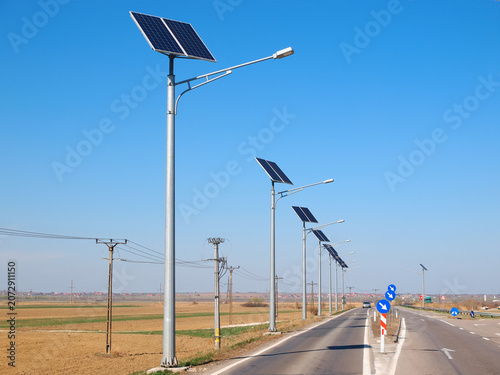 Street lighting pole with photovoltaic panel and LED lamp lights