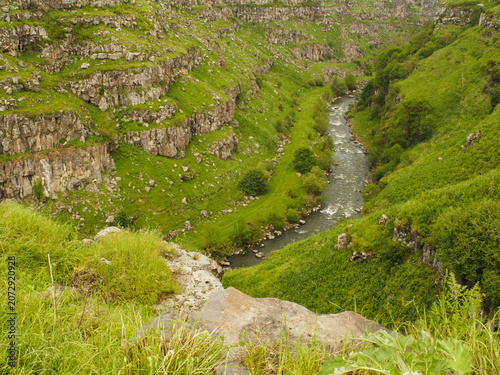 Photography horizontal photo of a breathtaking green canyon landscape with a fast mountain r