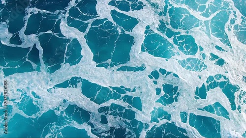 Aerial View of Crystal Blue Ocean Waves and White Sea Foam Creating Dynamic Marine Water Texture Background for Coastal Nature Scenes