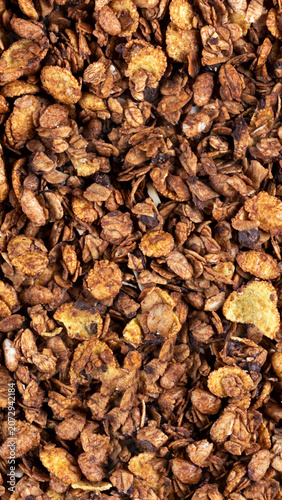Granola cereal. Delicious breakfast food, healthy snack, or topping. Natural toasted oats, nuts, and dried fruit create textured background