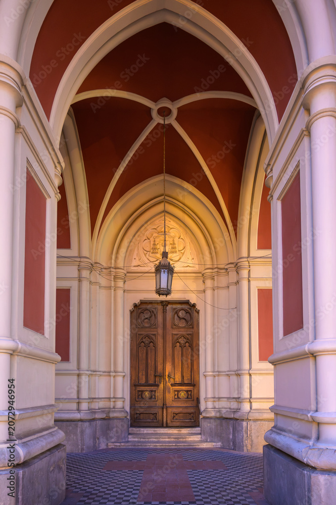 Fototapeta premium Gothic Portal and Carved Wooden Door of the Name of Mary Church