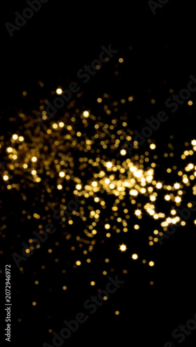 Golden glitter sparkles on black background, abstract festive light overlay for celebrations