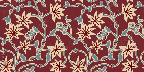 Seamless block print floral pattern with hand-carved leaf and berry vines on a dark red background.