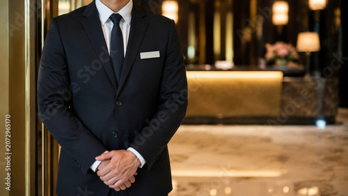 Professional concierge standing in a luxury hotel lobby