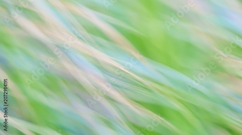 Obraz na plátně Blurry abstract background with green and white streaks moving diagonally quickl