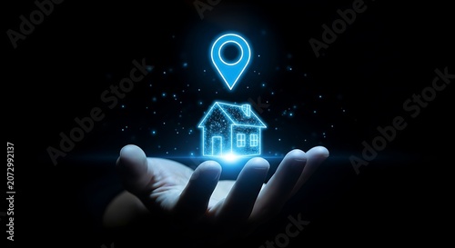 Glowing blue house icon with location pin above a hand in dark background