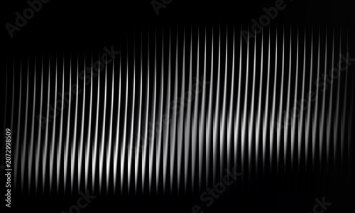 Lines of vertical silver metal creating abstract pattern on black background