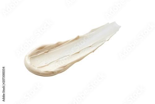 A smooth smear of thick beige cosmetic cream or skincare lotion on a white background, showing texture and ridges from a spatula application