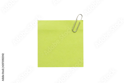 A single square lime green sticky note paper attached with a silver metal paperclip, isolated on a solid white background, for office use