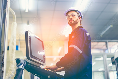 Female engineers checking or maintenance electronic in AI Robot, robot arm in the manufacturing automation and robotics manufacture room.