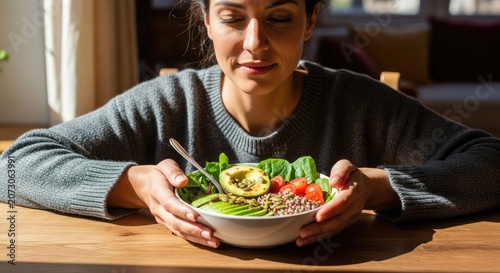Woman holding a bowl of fresh healthy salad.