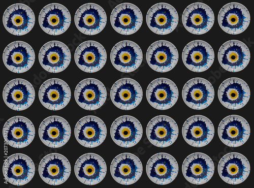 Creative pattern made of colorful blue and yellow evil eye on black background. 