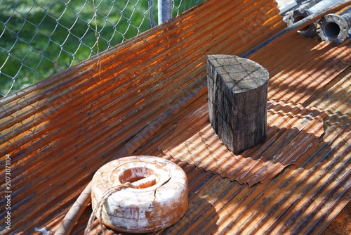 Rusted corrugated metal sheet with vintage industrial objects