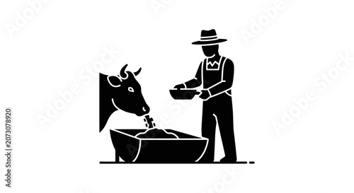 Fotografie Farmer provides feed to a cow inside a stable to maintain livestock health on a modern agricultural family farm