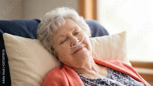 Elderly woman resting with a nasal oxygen cannula. Senior female patient sleeping comfortably during oxygen therapy at home. Healthcare and recovery concept