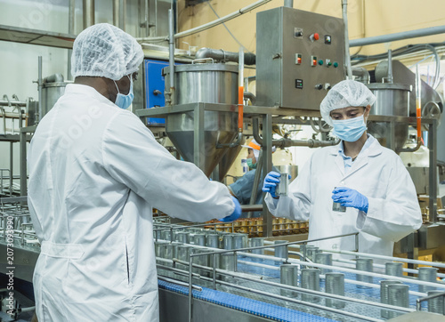 Vászonkép Engineers inspecting food production with tablet