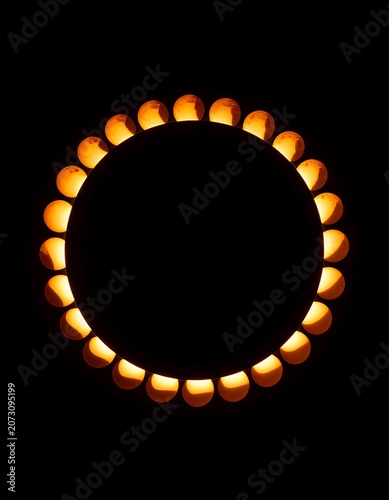 A circular arrangement of glowing orange lights on a black background