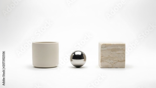 Minimalist 3D Geometric Shapes with Chrome Sphere and Marble Cube on White Background.