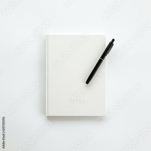 Clean Top View of White Notebook Mockup with Black Pen on White Backdrop.