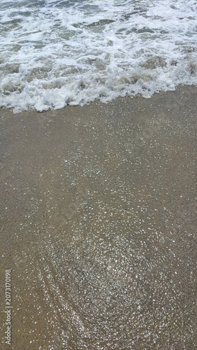 waves on a pristine coastal sandy beach