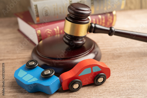Fotografie Car accident lawsuit and insurance, Judge hammer with car model.