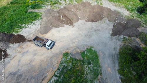 Cuadro en lienzo Aerial top-down view of a tipper dump truck at a construction site or quarry wit