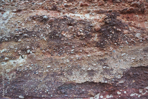 Canvas Print Natural conglomerate rock texture with mixed gravel and pebbles embedded in red sediment, abstract geological background