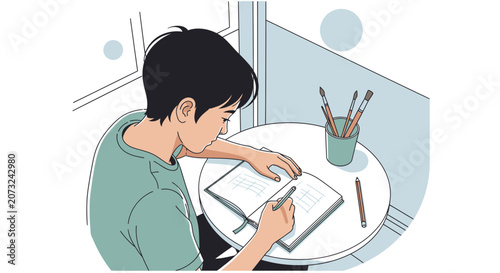 Young Boy Drawing in Sketchbook at Table
