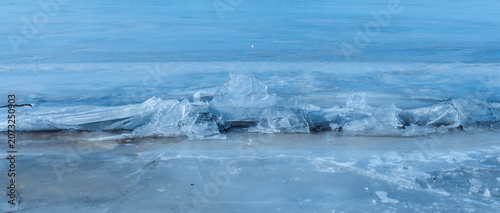 Quadro su tela The abstract background of ice structure in a river landscape