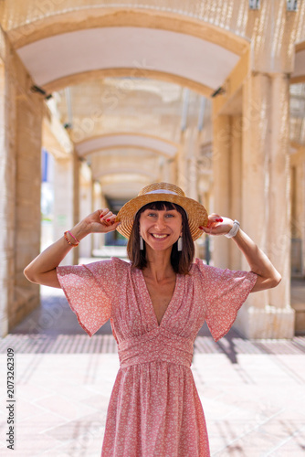 A young woman stands on an old street in Jerusalem and smiles. A Jewish woman. A trip to Israel.