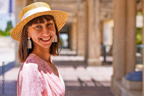 A young woman stands on an old street in Jerusalem and smiles. A Jewish woman. A trip to Israel.