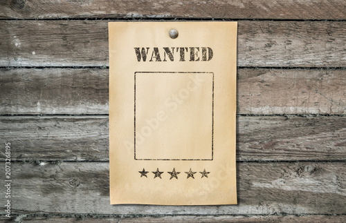 wanted poster on dirty wooden background