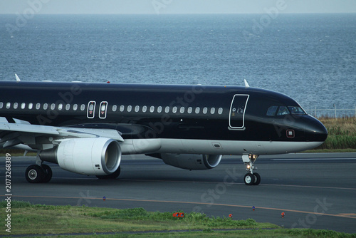Photos A private business jet parked on the tarmac.