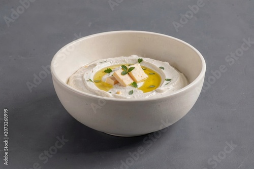 Creamy Haydari yogurt dip with garlic herbs cheese, garnished with thyme. Concept of vibrant, flavorful dish perfect for enhancing meals with rich, tasty solutions.