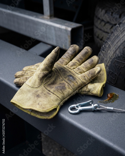 Professional still life shot of heavy industrial safety equipment resting on vehiclestep plate. Large highly diffused camera left light source simulates natural ambient overcast daylight.
