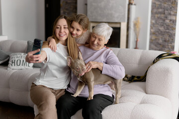 Happy family taking selfie with dog at home