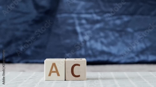 motivational word act, laying out  by hand from letters on wooden cubes, slow motion
