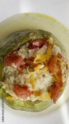 Zucchini stuffed with meat and rice, stewed in tomato sauce. Delicious and healthy home cooking.