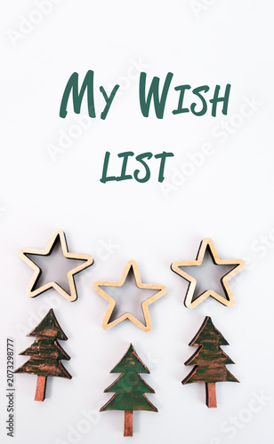 Festive wooden star and tree decorations arranged on a light background, creating a cheerful holiday atmosphere for Christmas and New Year celebrations with copy space