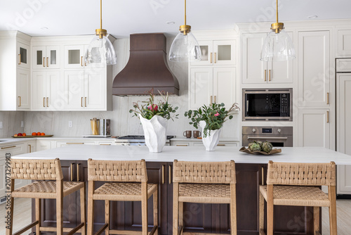 Bright Modern White Kitchen with Large Island and Woven Bar Stools