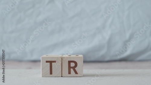 motivational word try, laying out  by hand from letters on wooden cubes, slow motion
