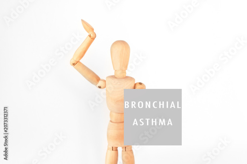 Wooden mannequin gestures about bronchial asthma