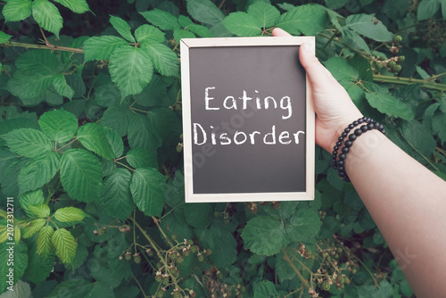 Hand Holding Chalkboard Sign Displaying Eating Disorder